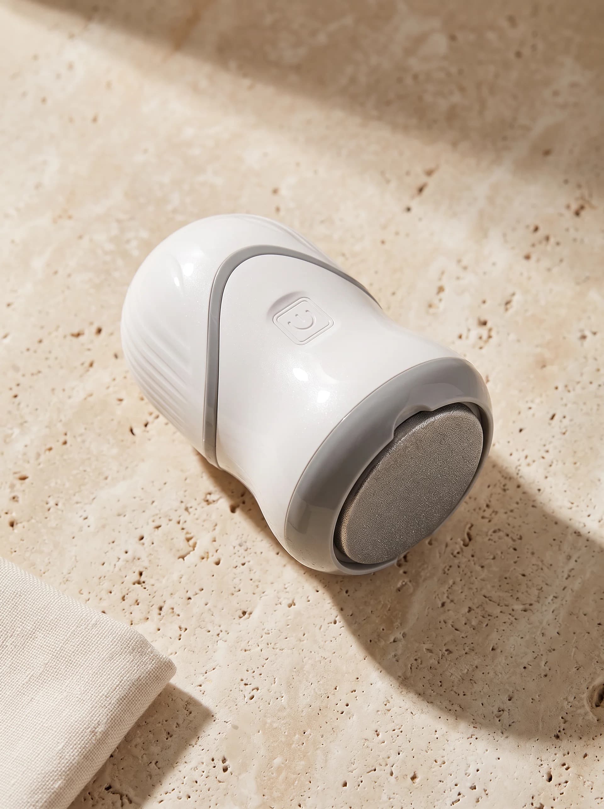 CALIRAE SmoothVac resting on warm travertine stone